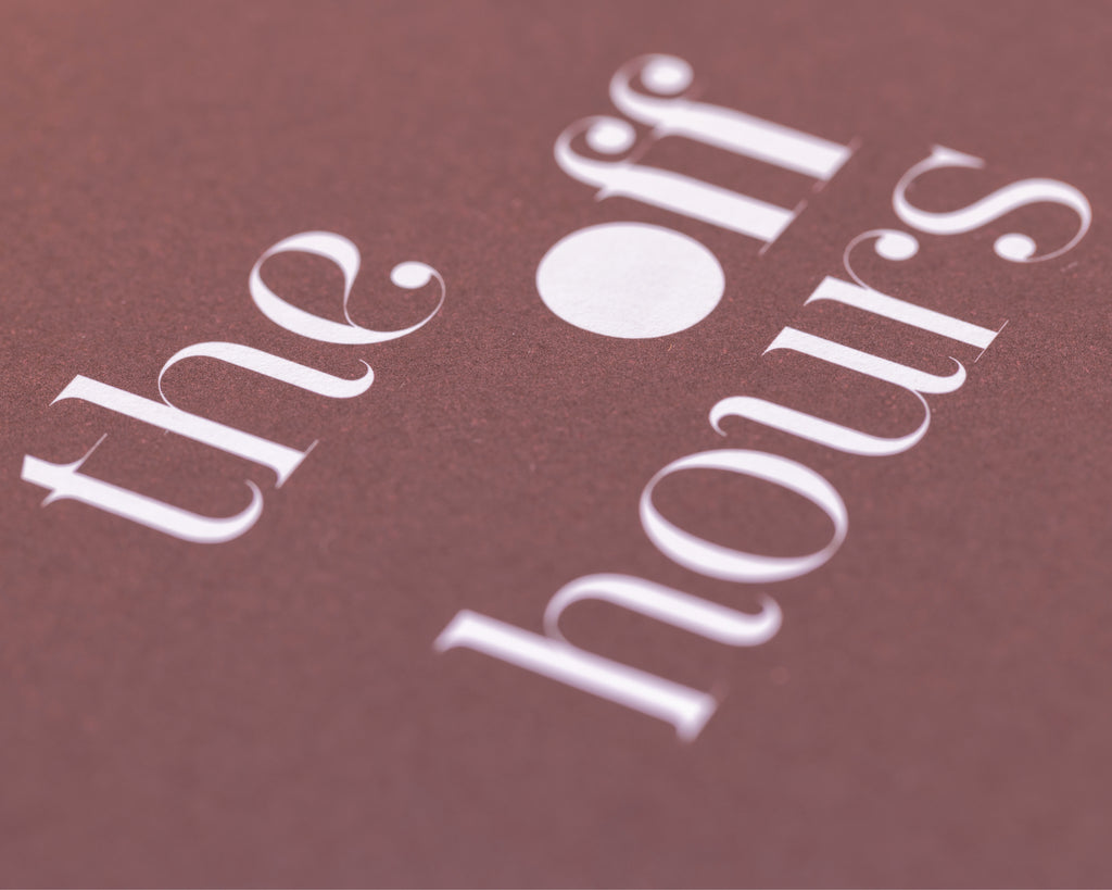 Close-up of The Off Hours Book I cover showing textured paper and white typography