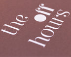 Close-up of The Off Hours Book I cover showing textured paper and white typography