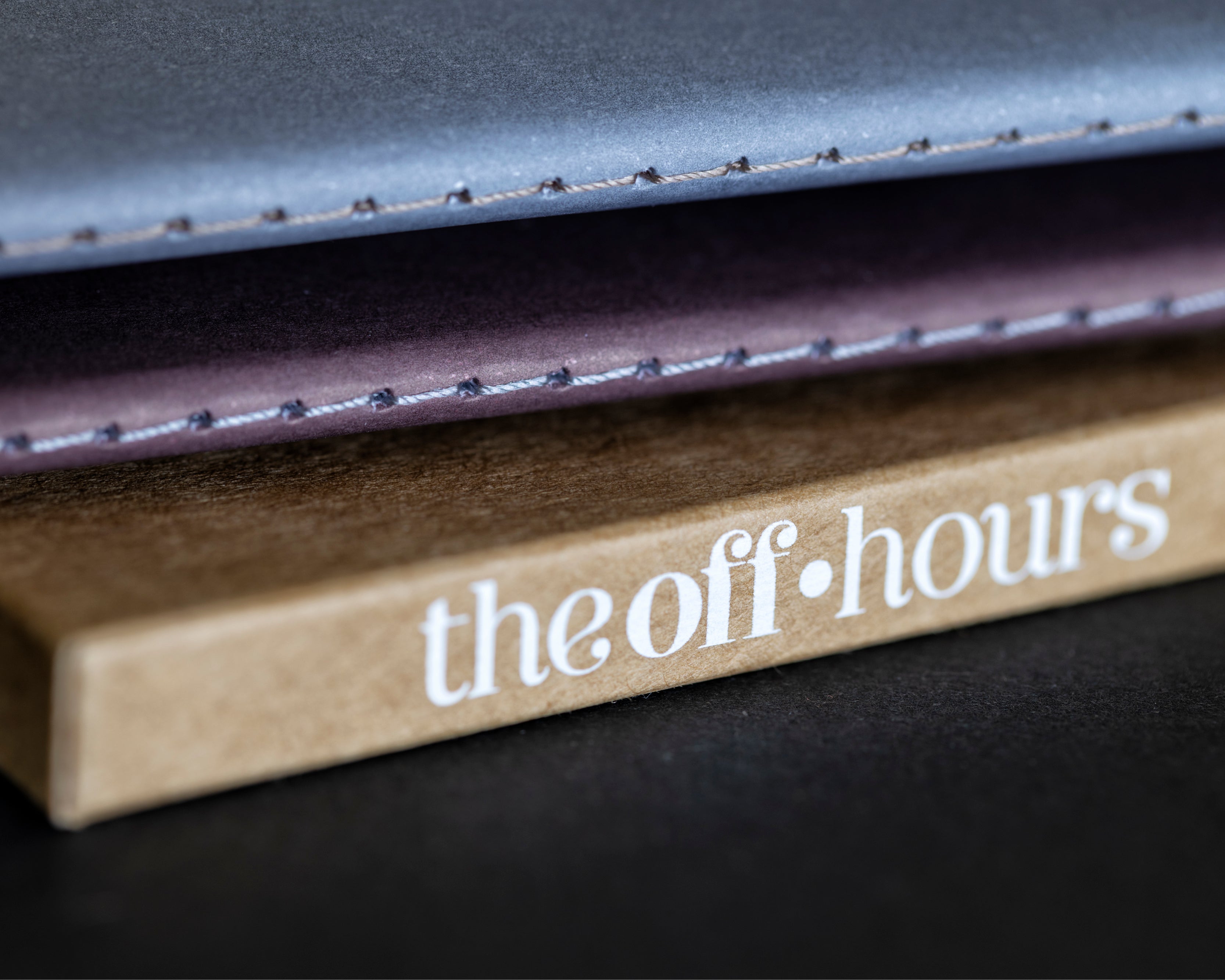 Close-up of The Off Hours 48-Hour Return hand-stitched books resting on the kraft slipcase