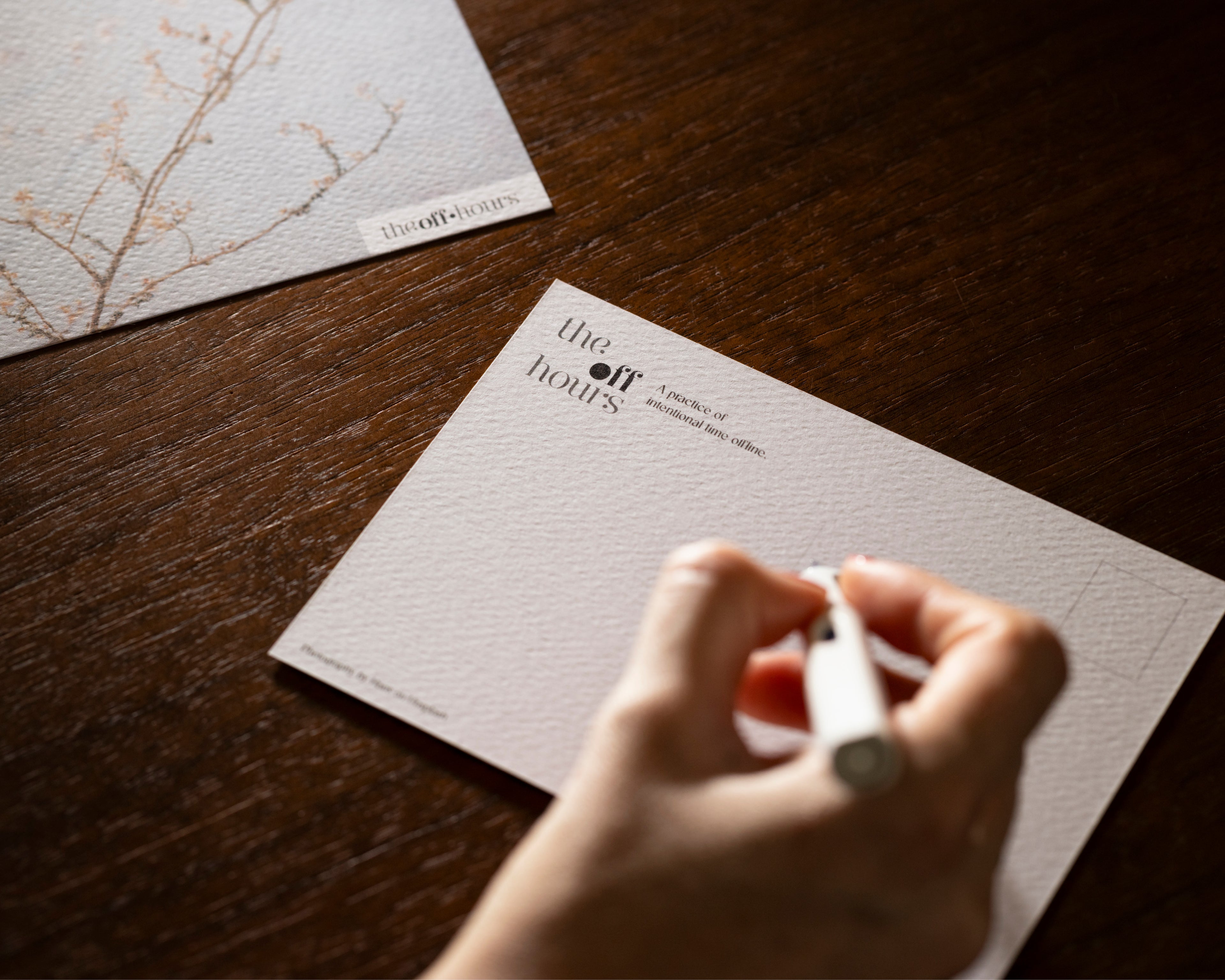 Writing on a branded postcard from The OFF Hours printed reflection set
