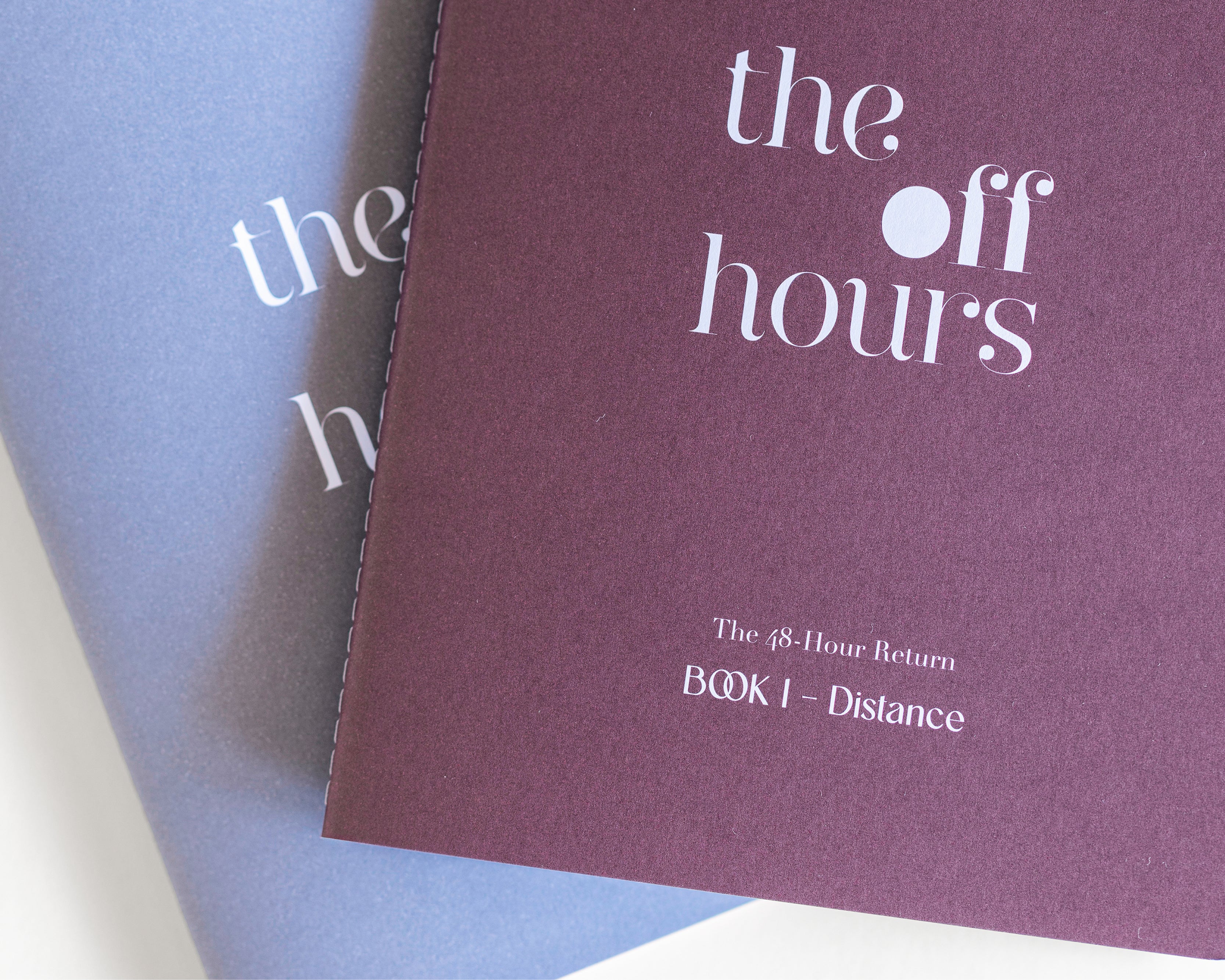 Close-up of The Off Hours logo printed on textured mauve book cover